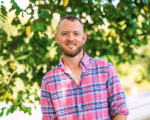 Image of men's life coach Ryan M. Graves in a pink and blue plaid shirt | Journey Guy Ryan